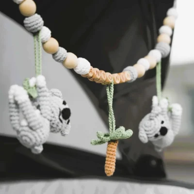 Personalized stroller chain with koala motif and the name Antonia attached to a stroller.